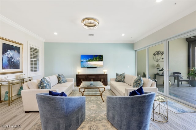 living room featuring crown molding and light hardwood / wood-style flooring