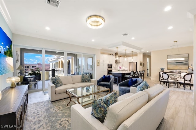 living room featuring light hardwood / wood-style flooring and ornamental molding