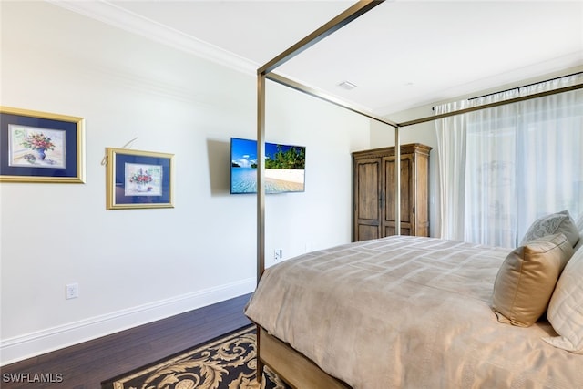 bedroom featuring wood-type flooring and crown molding