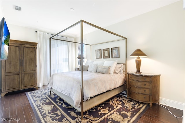 bedroom featuring dark hardwood / wood-style flooring