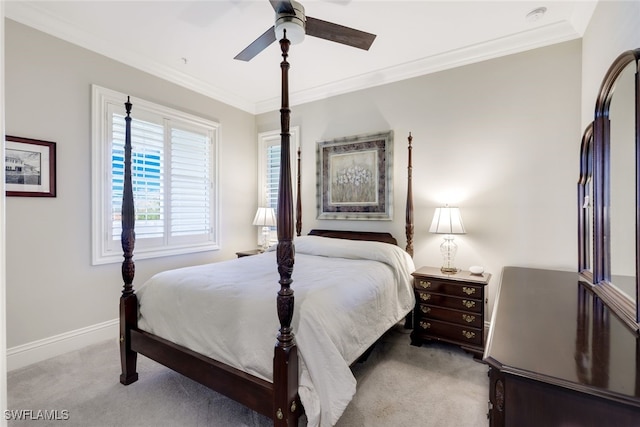 carpeted bedroom with ceiling fan and ornamental molding