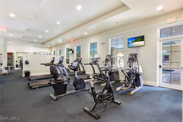 gym with a tray ceiling