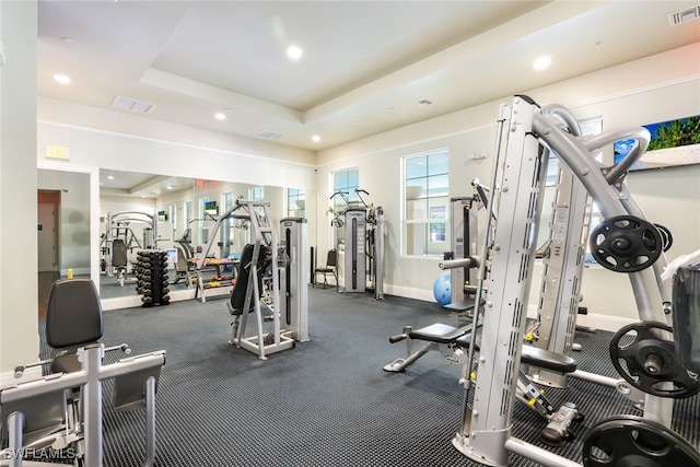 gym with a tray ceiling