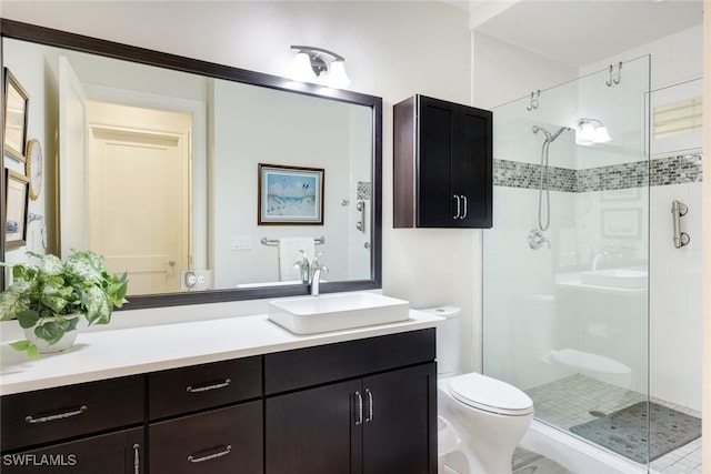 bathroom featuring vanity, toilet, and a shower with door