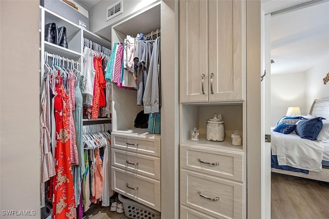 spacious closet featuring visible vents and wood finished floors