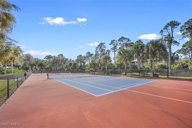 view of tennis court with community basketball court and fence