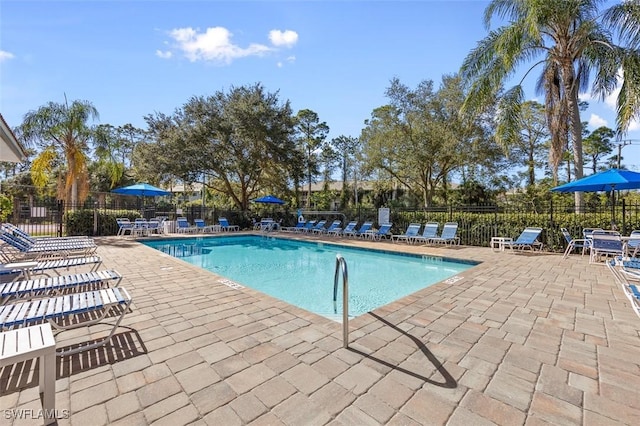 community pool featuring fence and a patio