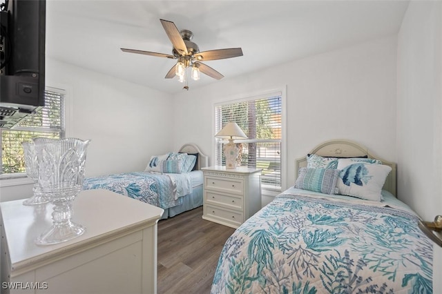 bedroom with dark wood-type flooring and a ceiling fan