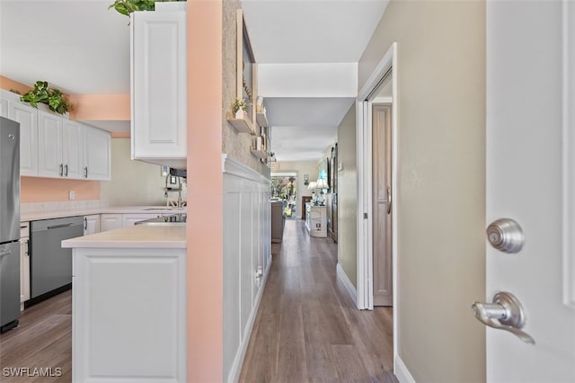 hallway featuring baseboards and wood finished floors