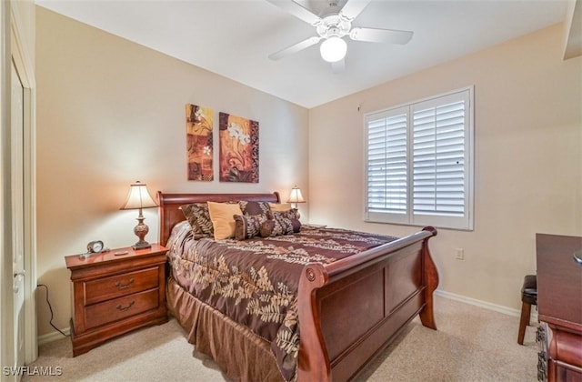 bedroom with ceiling fan and light colored carpet