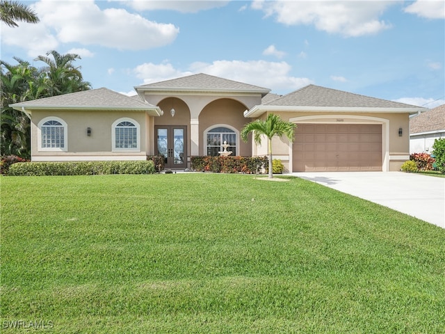 view of front facade featuring a front lawn, a garage, and french doors