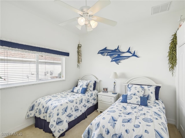 bedroom with light colored carpet and ceiling fan