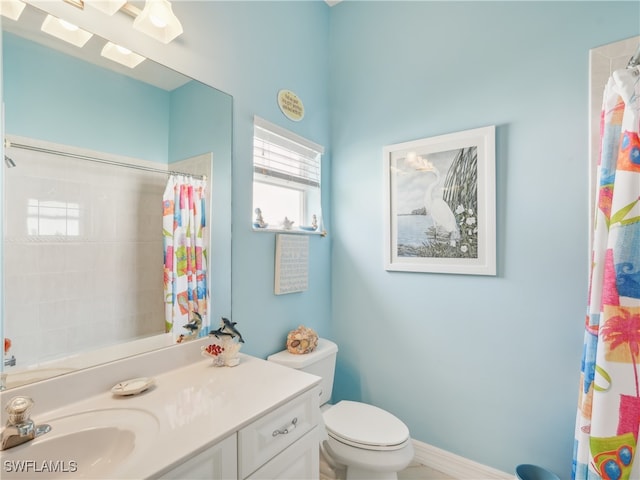 bathroom with vanity, toilet, and curtained shower