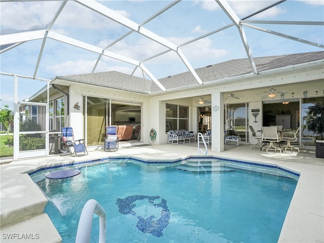 view of pool with a lanai, ceiling fan, and a patio area