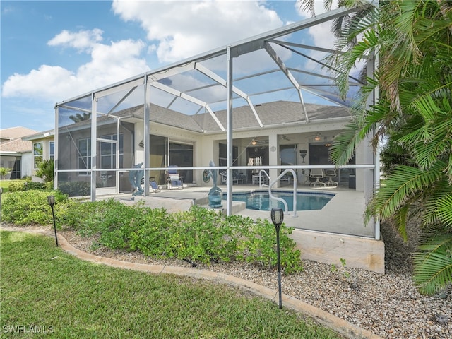 back of house with a lanai, ceiling fan, and a patio