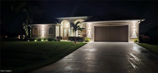 view of front of property featuring a yard and a garage