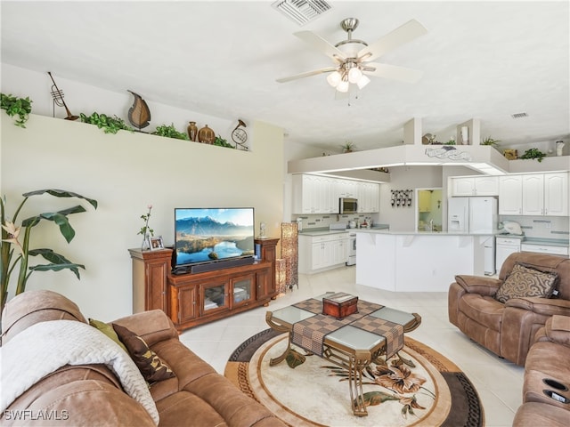 tiled living room with ceiling fan