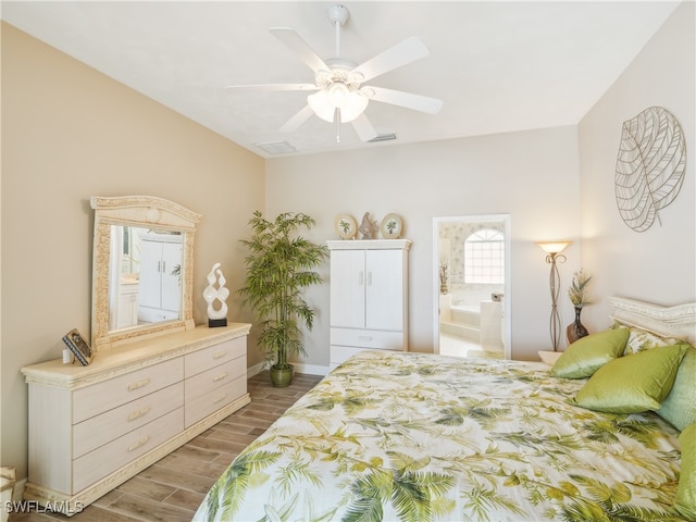 bedroom featuring wood-type flooring, ensuite bath, and ceiling fan