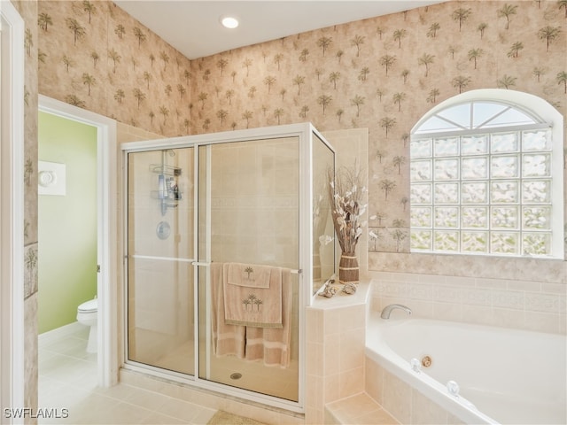 bathroom featuring tile patterned floors, separate shower and tub, and toilet