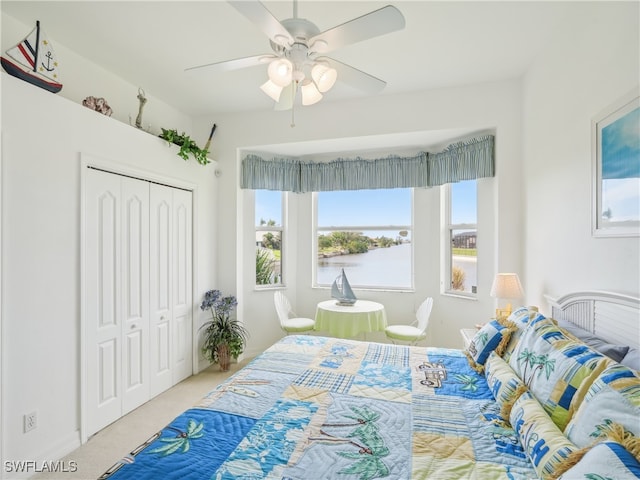 carpeted bedroom featuring a closet and ceiling fan