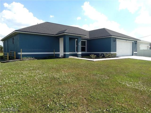 view of front of property featuring a garage and a front lawn