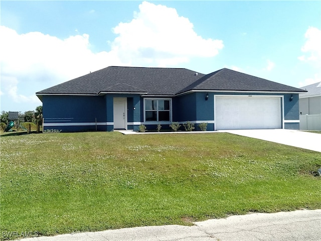 view of front of house featuring a garage and a front yard