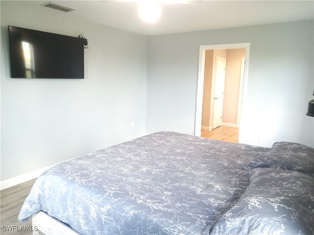 bedroom with wood-type flooring