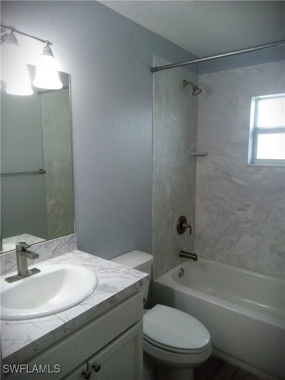 full bathroom with vanity, toilet, and tiled shower / bath