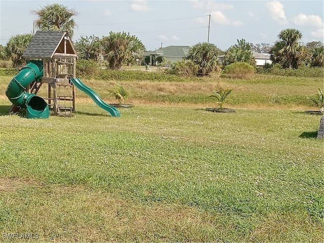 view of jungle gym featuring a lawn