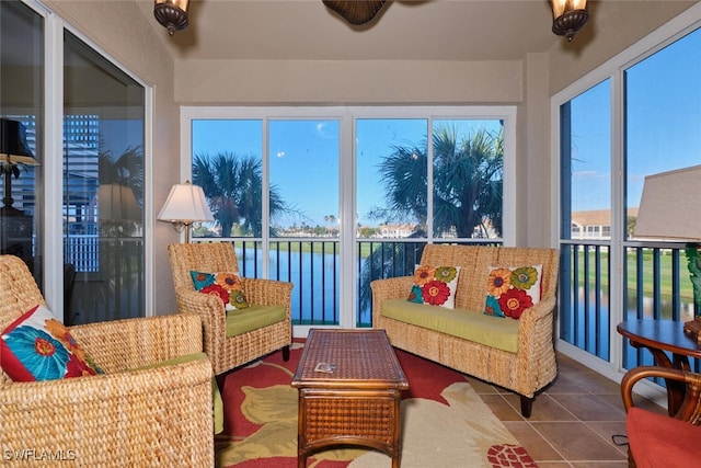 sunroom with plenty of natural light and a water view