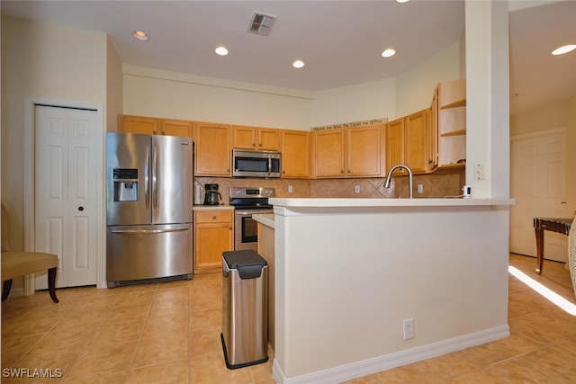 kitchen with light tile patterned floors, sink, appliances with stainless steel finishes, and tasteful backsplash