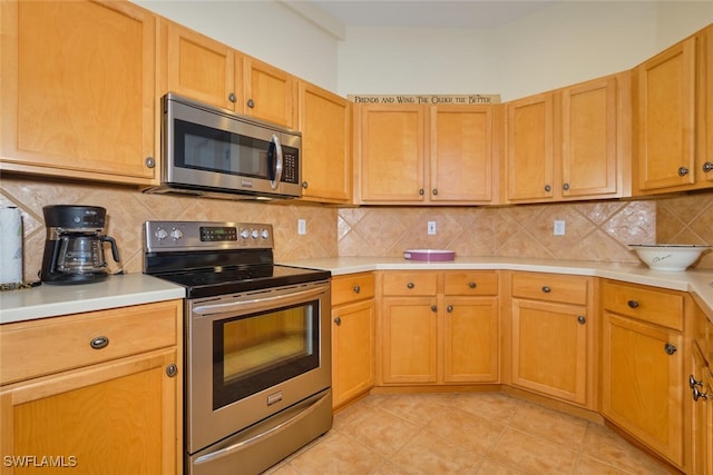 kitchen featuring light tile patterned floors, stainless steel appliances, and tasteful backsplash