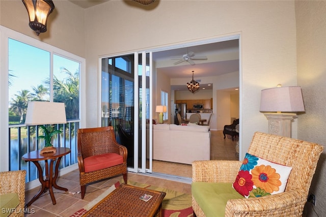 living area featuring ceiling fan and light tile patterned floors