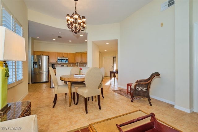 tiled dining area with a chandelier