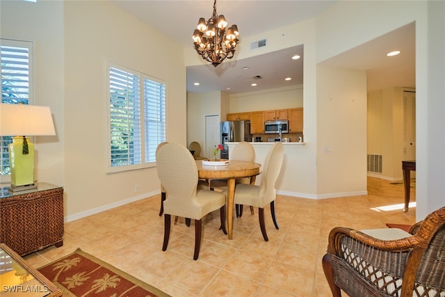 tiled dining area with a chandelier and a healthy amount of sunlight