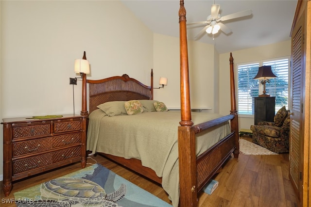 bedroom featuring dark hardwood / wood-style floors, ceiling fan, and lofted ceiling