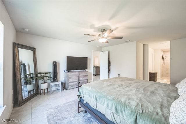 bedroom with light tile patterned floors, ensuite bath, and ceiling fan