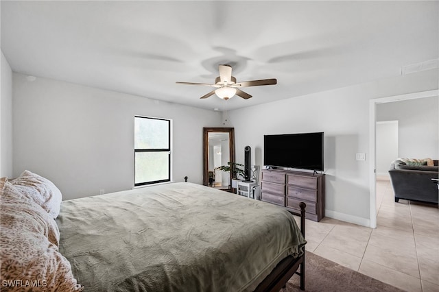 tiled bedroom featuring ceiling fan