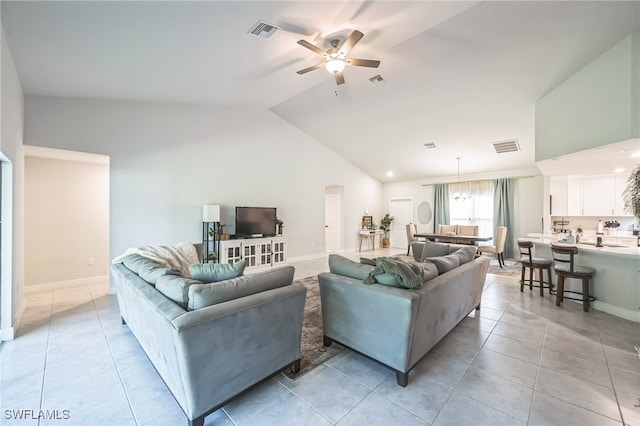 tiled living room featuring ceiling fan and high vaulted ceiling