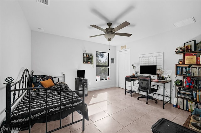 tiled bedroom featuring ceiling fan