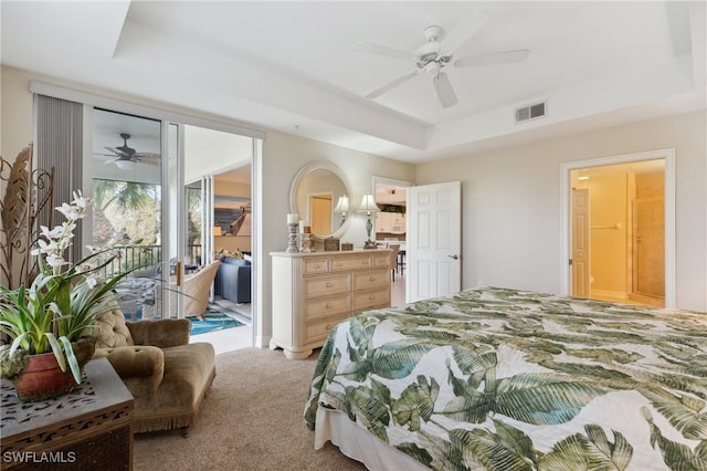 carpeted bedroom with a raised ceiling, access to exterior, and ceiling fan