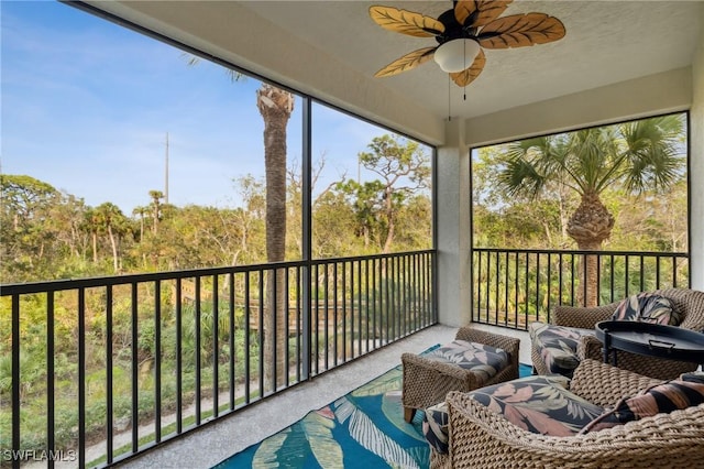 sunroom / solarium featuring ceiling fan