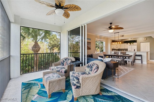 sunroom featuring ceiling fan