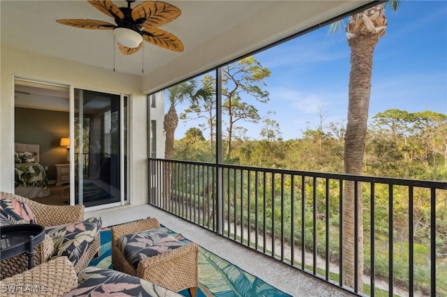 sunroom featuring a healthy amount of sunlight and a ceiling fan