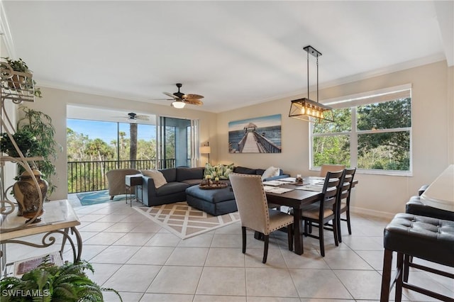 tiled dining area with plenty of natural light, ceiling fan, and ornamental molding