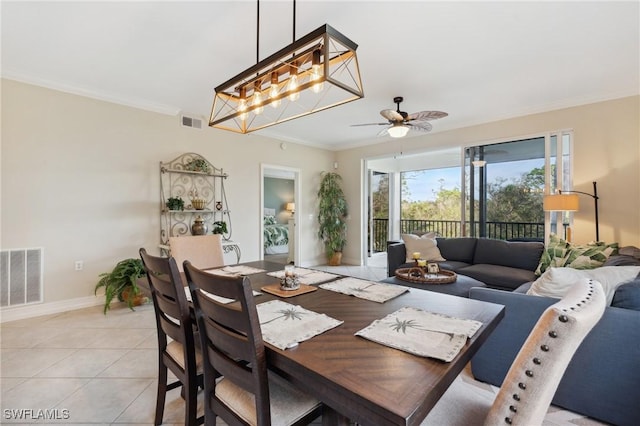 dining area featuring crown molding, light tile patterned floors, a ceiling fan, and visible vents