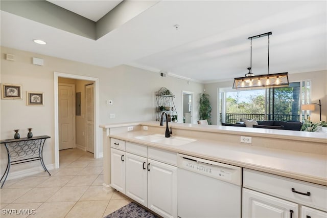 kitchen with dishwasher, light countertops, light tile patterned floors, white cabinetry, and a sink