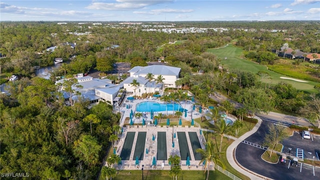 drone / aerial view with a forest view and view of golf course