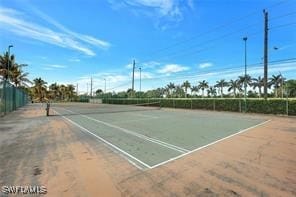 view of tennis court featuring fence