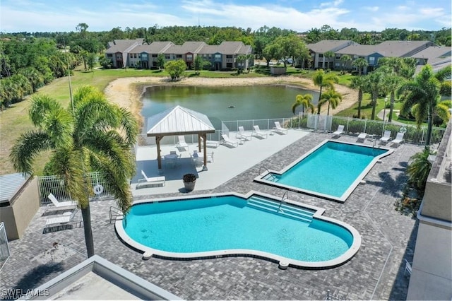 community pool with a gazebo, a water view, fence, and a patio
